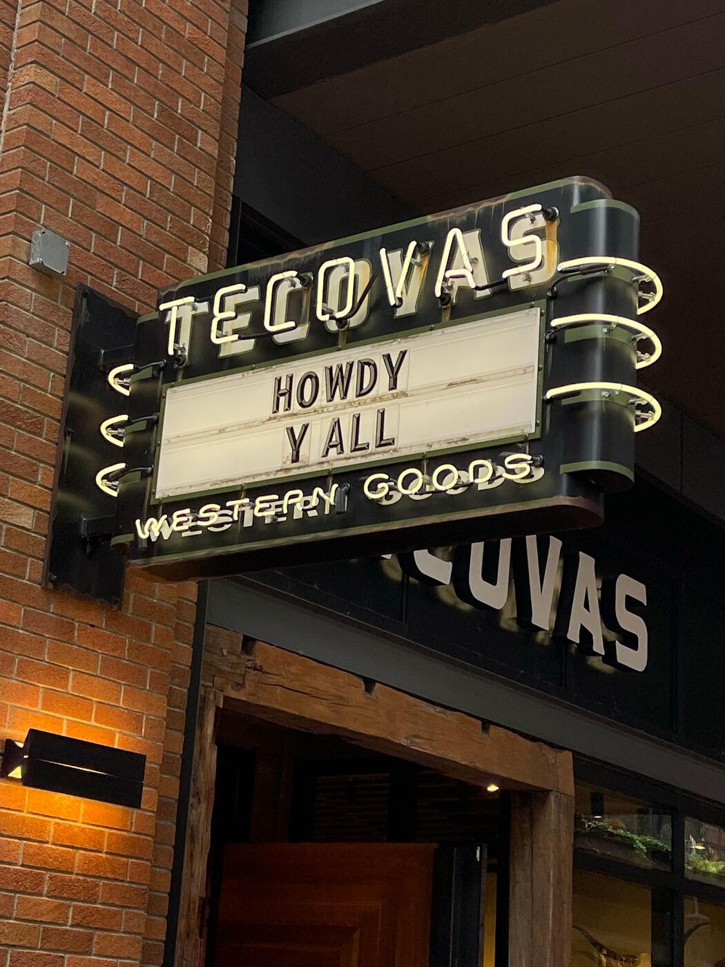 A retail marquee sign lit up at dusk